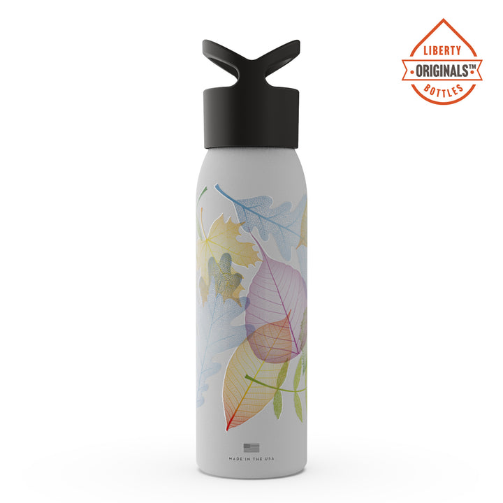 Colorful, delicate leaves on a white bottle