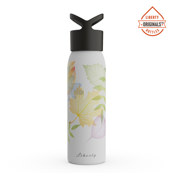Colorful, delicate leaves on a white bottle