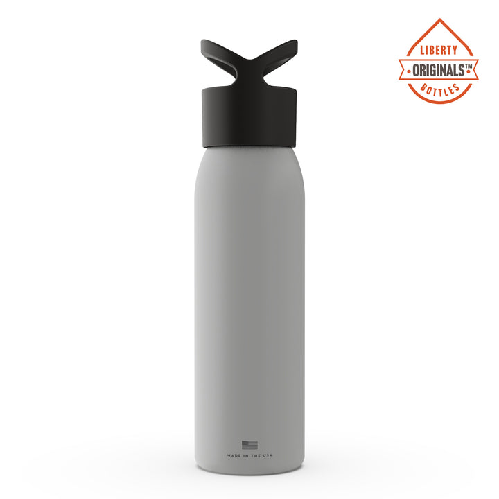 A grizzly in the mountains printed on a light grey bottle